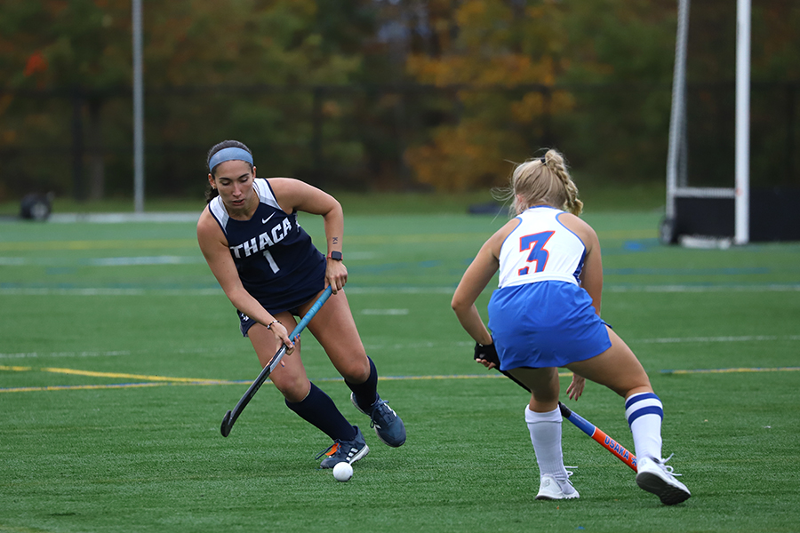 From left, junior striker Natalie Descalso rushes upfield and aims to get past Hawks senior midfielder Morgan Woolley in the Bombers 2–1 overtime victory Oct. 10.