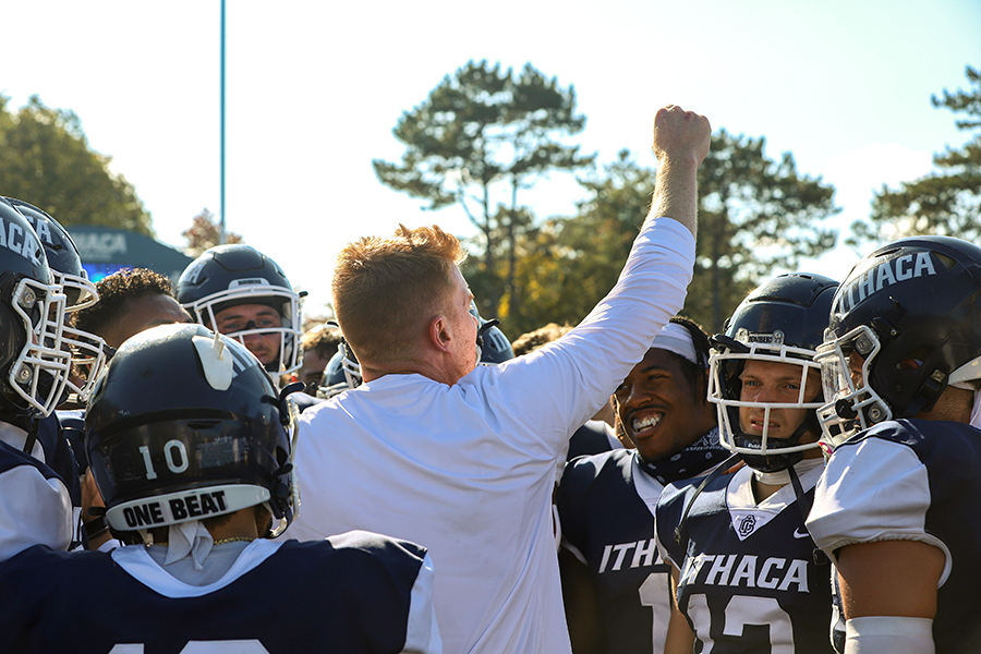 Head coach Michael Toerper calls the huddle following the Bombers 24–14 win over the Hobart College Statesmen.