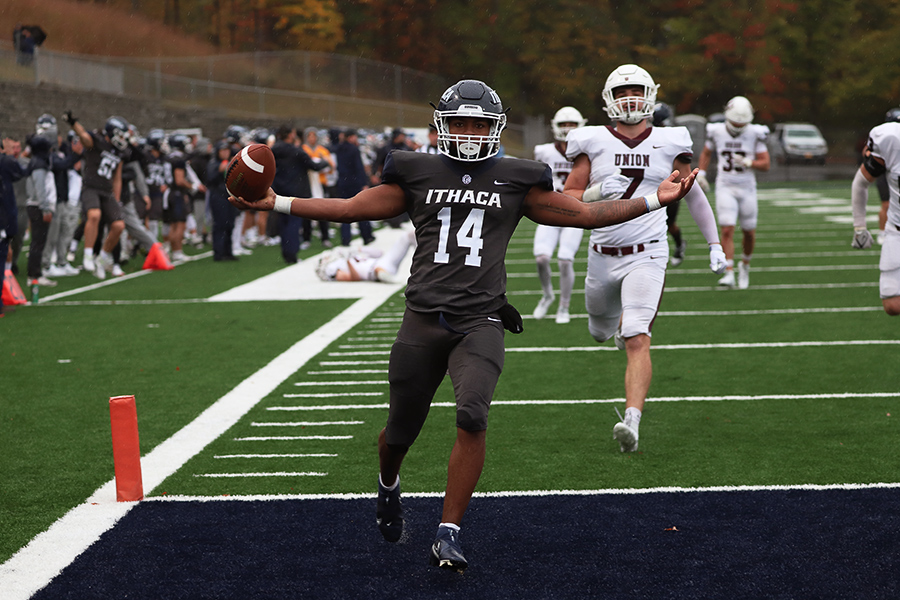 From left, senior running back Jalen Leonard-Osbourne celebrates after he trotted for a six yard touchdown run past Garnet Charger senior linebacker Spencer Goldstein in the Bombers 17–9 victory Oct. 14.