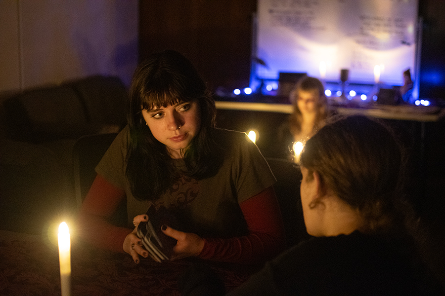 First-year student Abigail Mast shuffles her tarot cards before her reading at the Seance Halloween Party hosted by IC Pagans at Muller Chapel on Oct. 30. Students also wore costumes and enjoyed smores and candy.