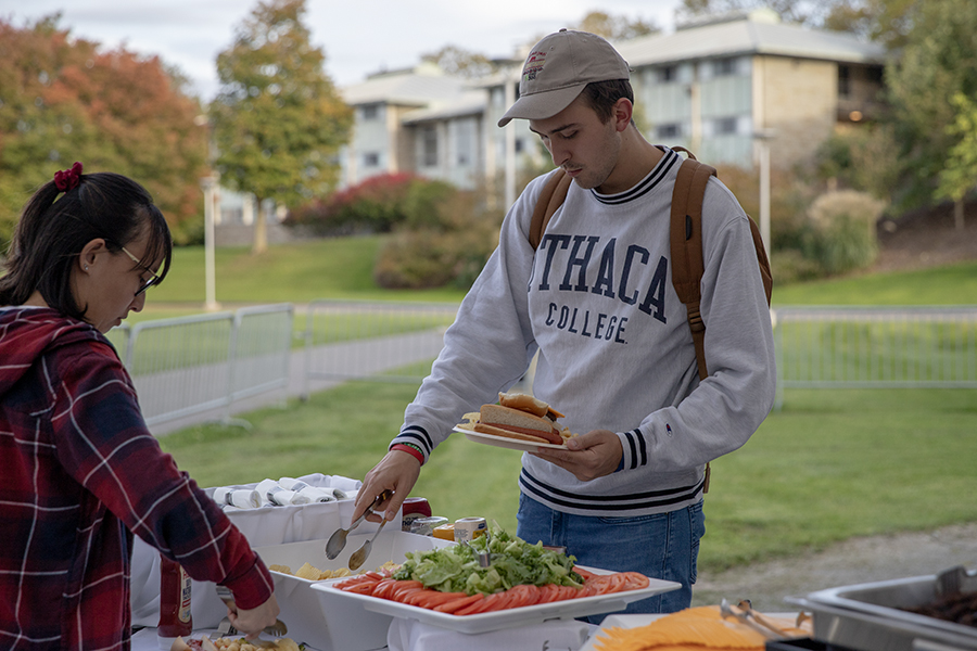 Senior Joey Albano fixes a plate of food at the Senior Class Kickoff Barbecue at the Campus Center Quad on Sept. 28. Along with free food and dessert, seniors had the opportunity to purchase their Senior Savings Card.