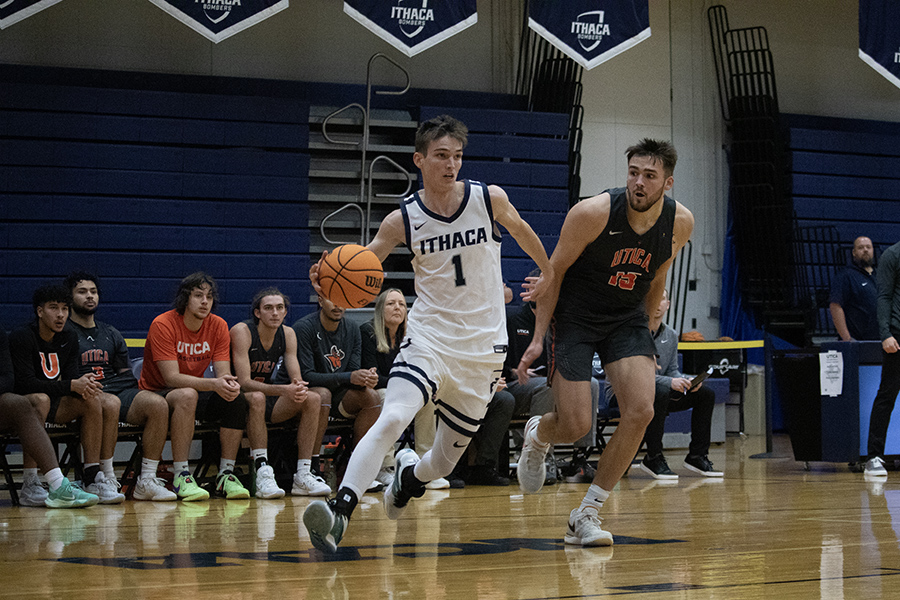 From left, junior guard Logan Wendell drives into the lane from the right wing with Pioneers senior forward Damien Call trailing to his left in the Bombers' 82–71 defeat Nov. 27.