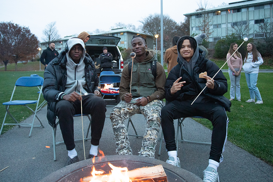 From the left, sophomore Garen Igho, junior DAndre Walker and junior Brian Martinez roasting smores by a fire at the BIOPOC Unity Centers S’mores on the Quad  event with BRASA and B4B on Nov. 3.