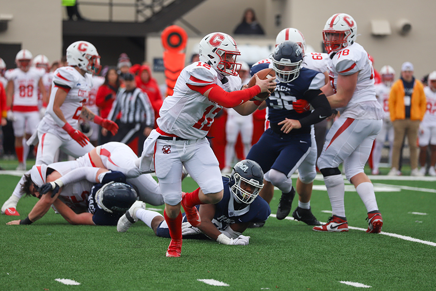 SUNY Cortland junior quarterback Zac Boyes  scrambles right to try and extend the play after the pocket was broken down by three Bombers defenders.