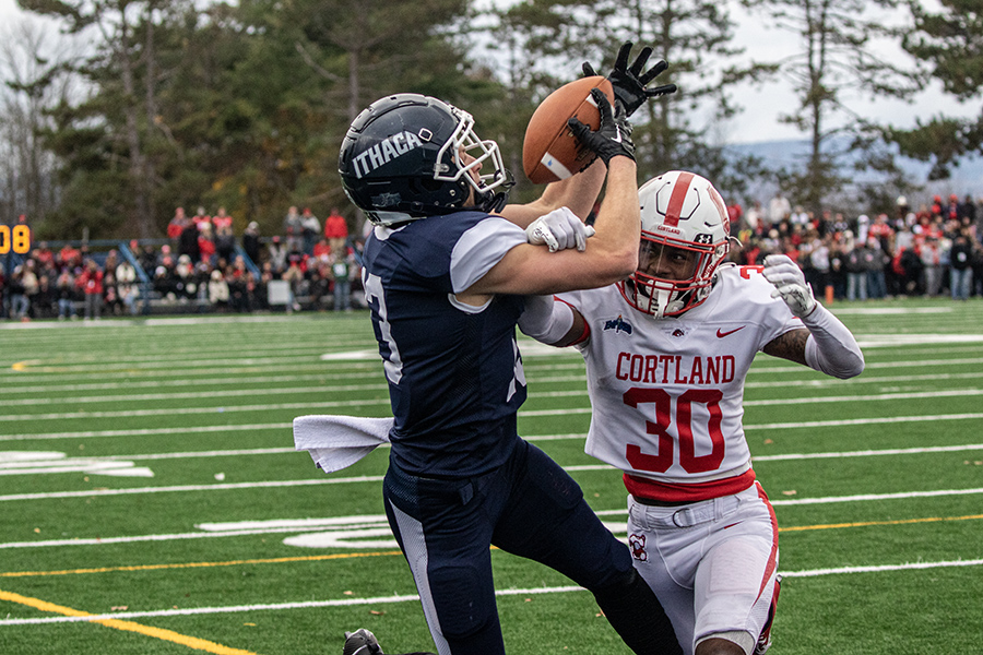 From left, senior wide receiver Sam Kline receives a pass over first-year defensive back Naz Jean-Lubin during the 64th annual Cortaca Jug.