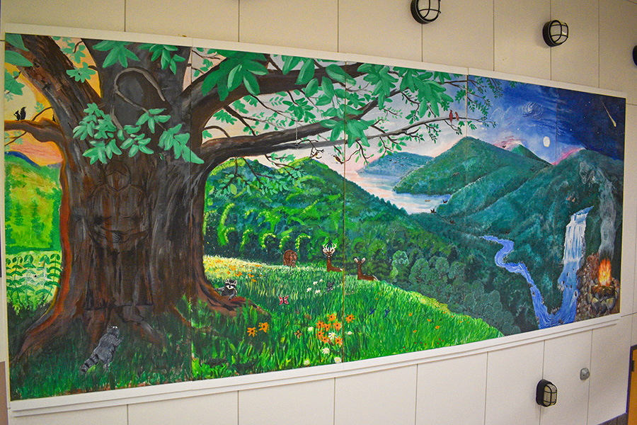 The mural above in Williams Hall was painted by an Indigenous artist, Eli Thomas, and students of the 2016 Native American studies program. 