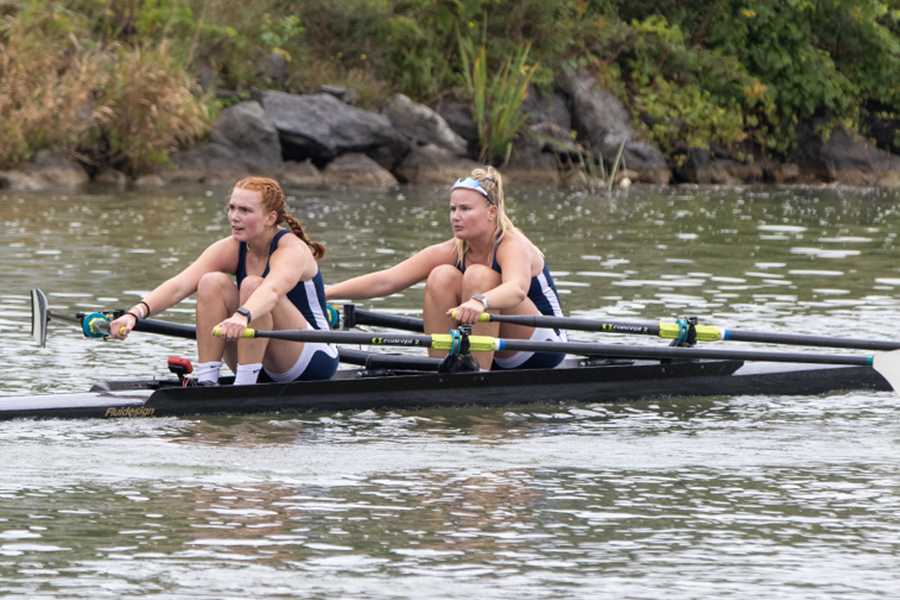 From left, junior rower Lily Babcock and senior rower Erin Trojan compete during the Cayuga Sprints on Sept. 24.