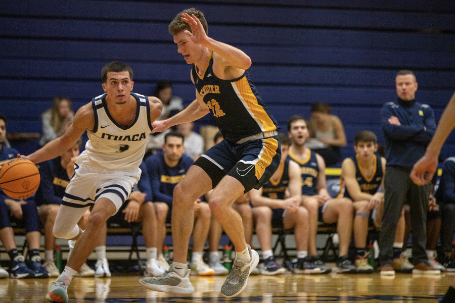 From left, Bombers junior guard Aidan Holmes drives right down the baseline as Yellowjackets junior forward Logan Jagodzinski tries to defend the penetration into the lane.