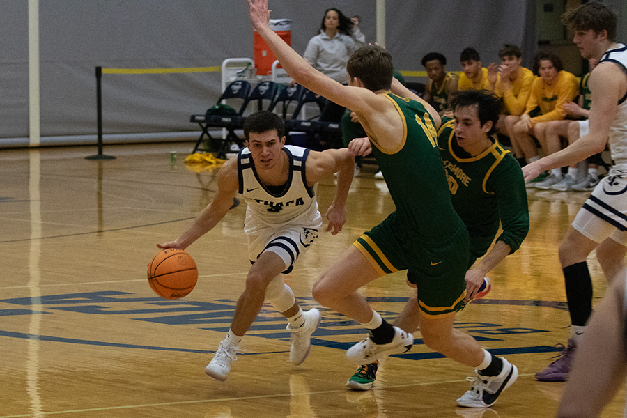 Bombers junior guard Aidan Holmes looks forward as he absorbs contact from Thoroughbreds junior guard Jake Walsh and heads toward sophomore forward Joey Skoric.