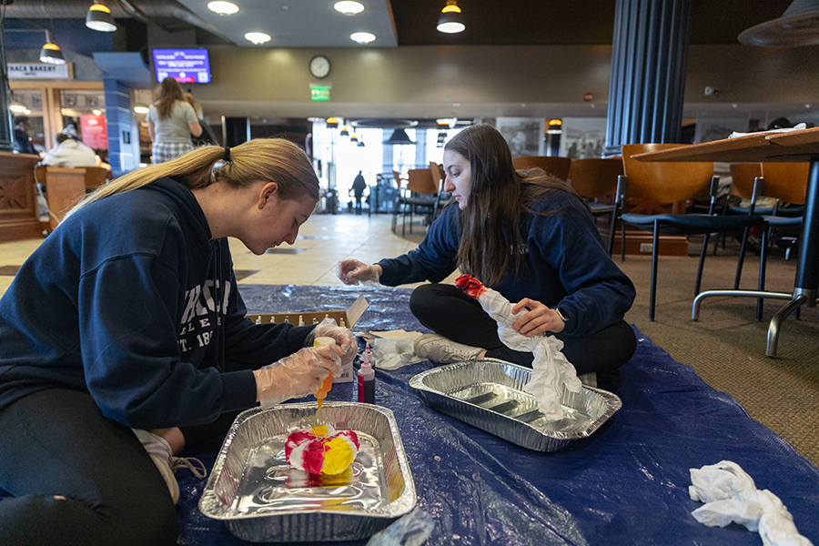 Abby OShey and Maddie Berg make tie dye shirts at a BomberTHON event Feb. 25th in IC Square. 
