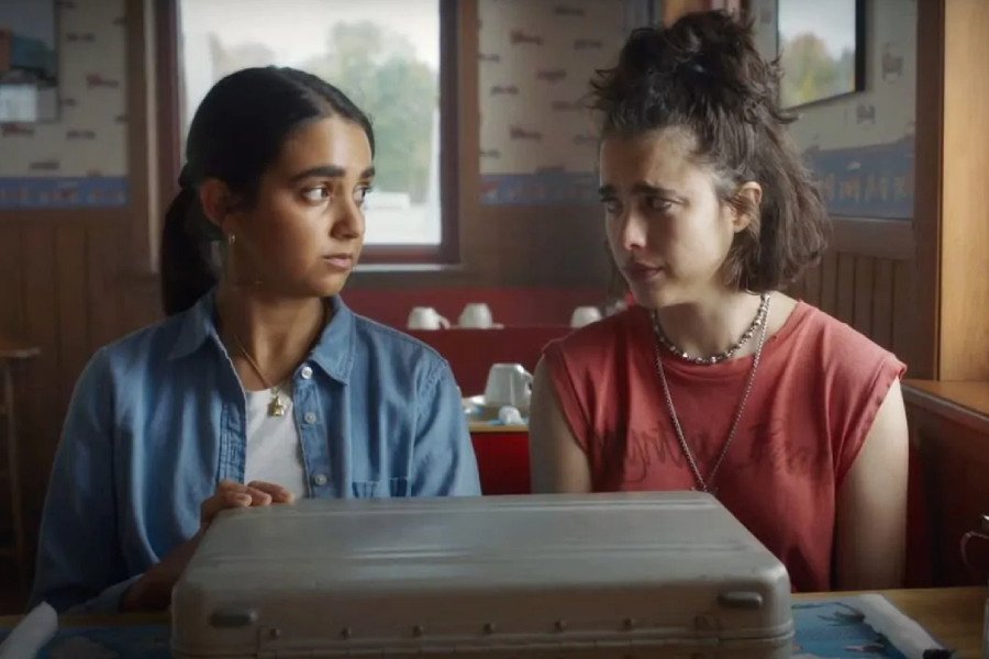 From left to right, Marian (Geraldine Viswanathan) and Jamie (Margaret Qualley) discuss what their plan of action should be Drive-Away Dolls.