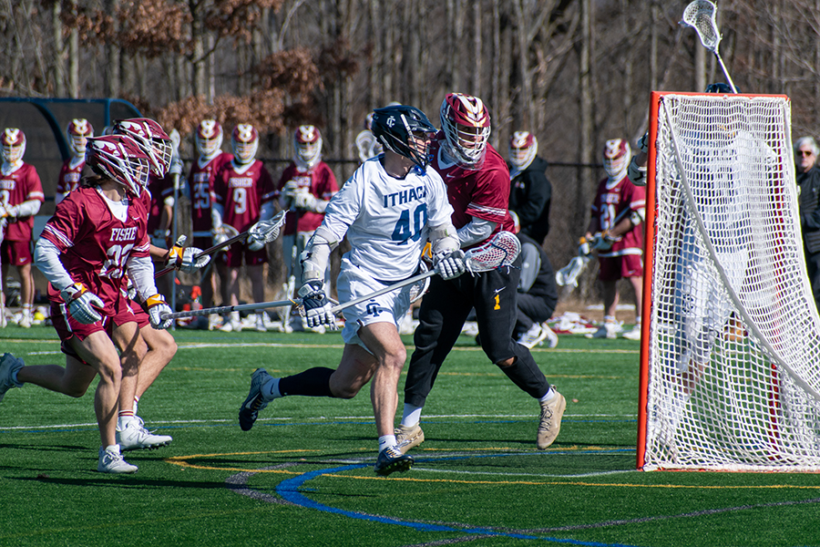 Senior attacker John Sramac battles through St. John Fisher defenders on Feb. 25. The Bombers defeated the Red Dragons 12–11 after a back and forth battle.