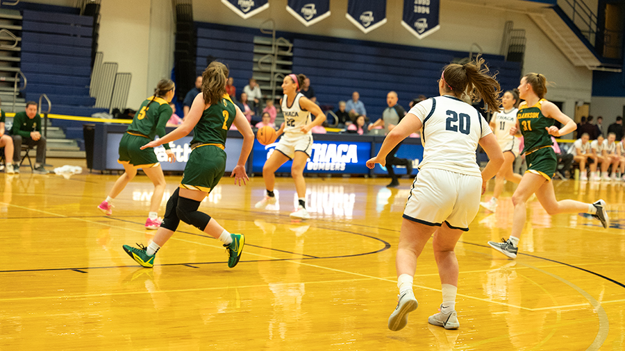 Graduate student guard Camryn Coffey dribbles the ball up top against a couple of Golden Knight defenders while senior guard Hannah Polce positions herself on the right wing.