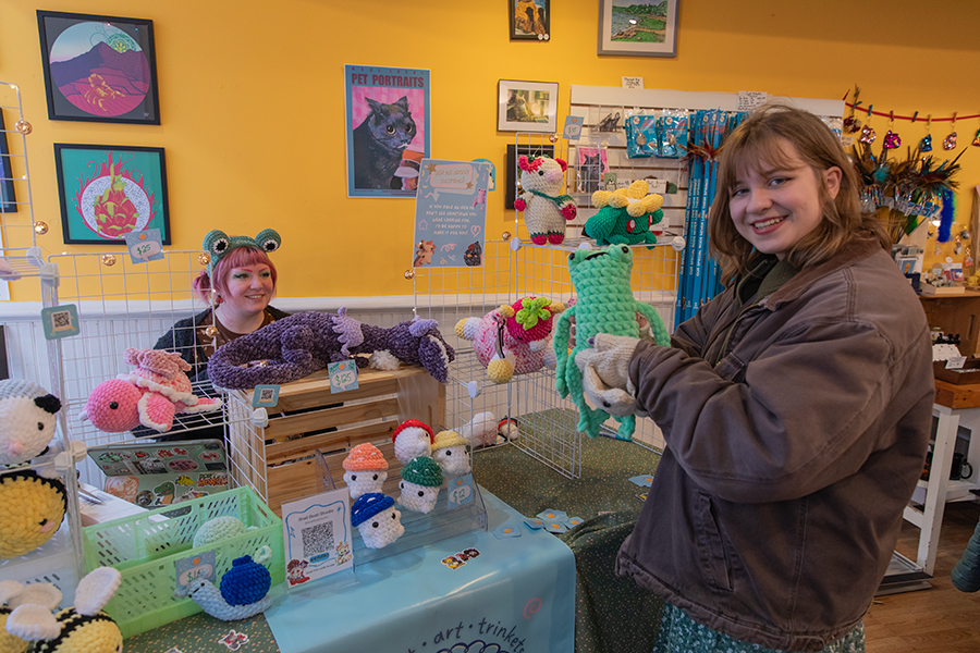 Kelby Woodside, owner of Snailboat Studio, and Ithaca College sophomore Katie Oliver pose with the variety of crochet animals that were available for purchase at this year’s Fairy Fest on The Commons.