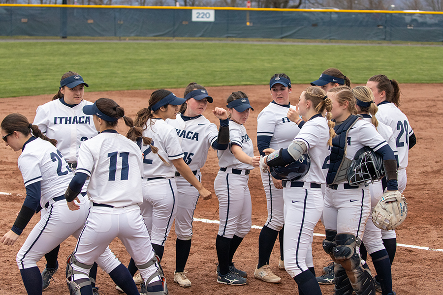 The Ithaca College softball team break a huddle along the baseline during the teams doubleheader victories on March 26. Junior Anna Cornell pitched a no-hitter in game one.