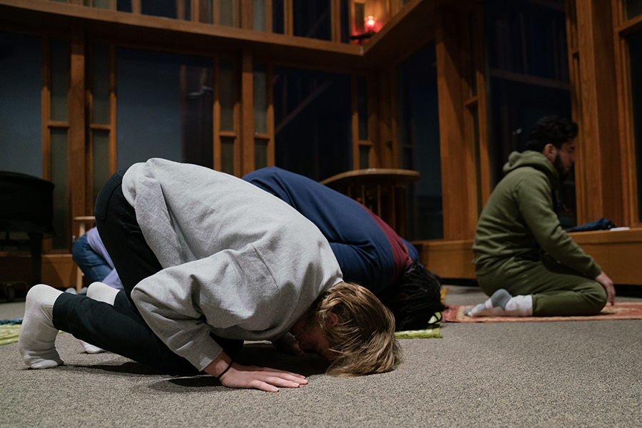 Sophomore Jack Violi prays with other students after the Iftar Community Dinner in Muller Chapel on Sunday March 17. 