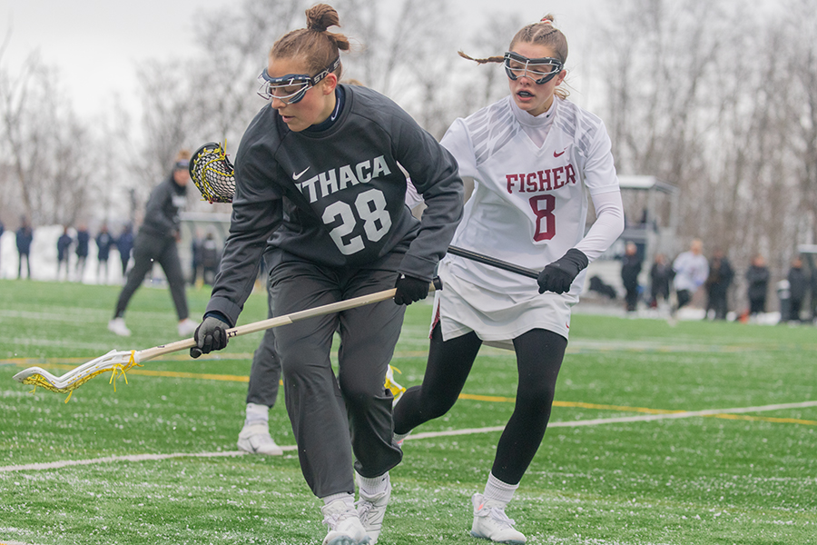 Bombers senior attack/midfield Chloe Nordyke tracks the ball as Cardinals junior defense Jillian Genther trails behind in the Bombers 13–11 victory March 23.
