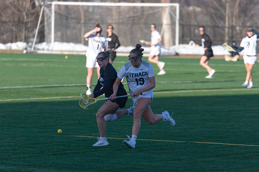 Senior midfielder Caroline Wise runs and battles a University of Scranton defender in a 13–9 victory February 25. The Bombers stand atop the Liberty League with a 7–0 conference record.