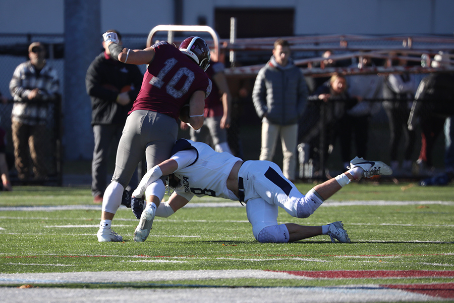 Former All-American safety Derek Slywka 23 goes low to wrap up Springfield College senior running back Blane Hart on Nov. 18, 2023.  Slywka has two NFL rookie mini camp opportunities coming up with the Chiefs and the 49ers.