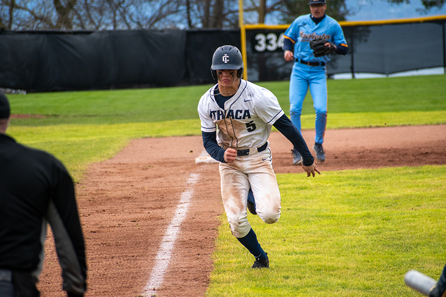 Center fielder Collin Feeney eyes home plate and sprints in an effort to cross the plate against the University of Rochester on April 21.