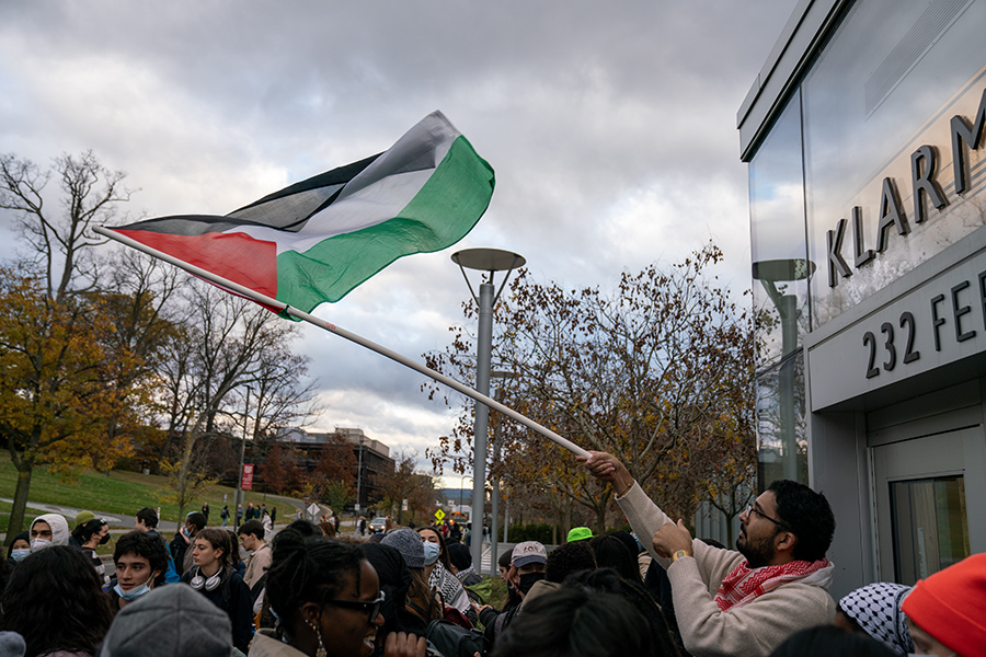 One of the participants of the die-in and protest waves the Palestinian flag outside of Klarman Hall at Cornell University on Nov. 9. 