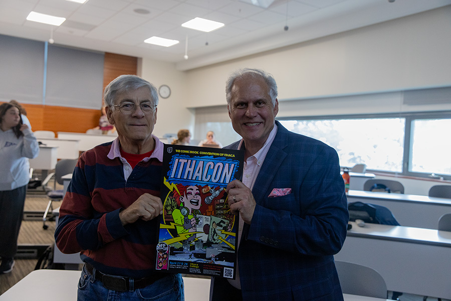 Bill Turner,founder of the first ITHACON, and Ed Catto, instructor of the ITHACON course in the School of Business, hold the 2024 ITHACON phamphlet.