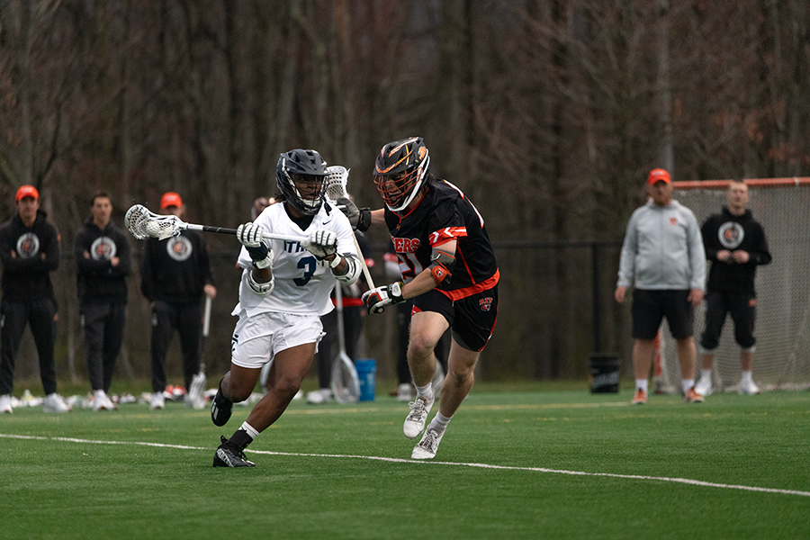 Junior attack/midfield Sekou Ibrahima battles to get by Tigers' senior midfield Caiden Perry on April 10. The Bombers fell to 6–6 after the loss.