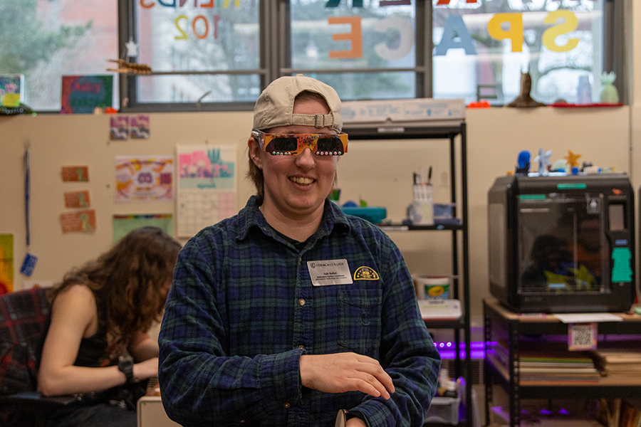 Ash Bailot, makerspace faculty coordinator, at the solar eclipse crafting event organized April 4 in the Makerspace. On a first-come first-serve basis, students could design their own eclipse glasses. 
