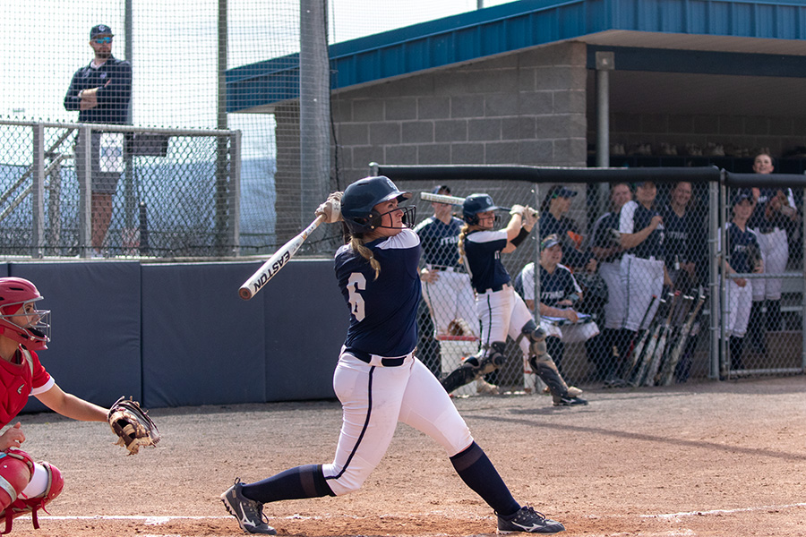 First-year+student+second+baseman+Elise+Waddington+follows+through+with+her+swing+against+the+SUNY+Cortland+Red+Dragons+on+April+23.+Waddington+contributed+two+RBIs+in+the+second+game.