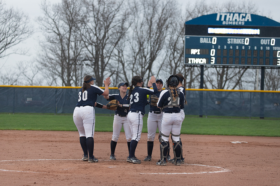 First-year pitcher Taylor Brunn meets her teammates in the pitchers circle as the Bombers celebrate a strikeout in a game against the Rensselaer Polytechnic Engineers on April 12.
