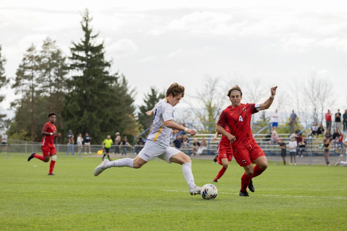 Senior midfielder Landon Hellwig prepares to kick the ball as senior defender Cade Denlinger moves in.