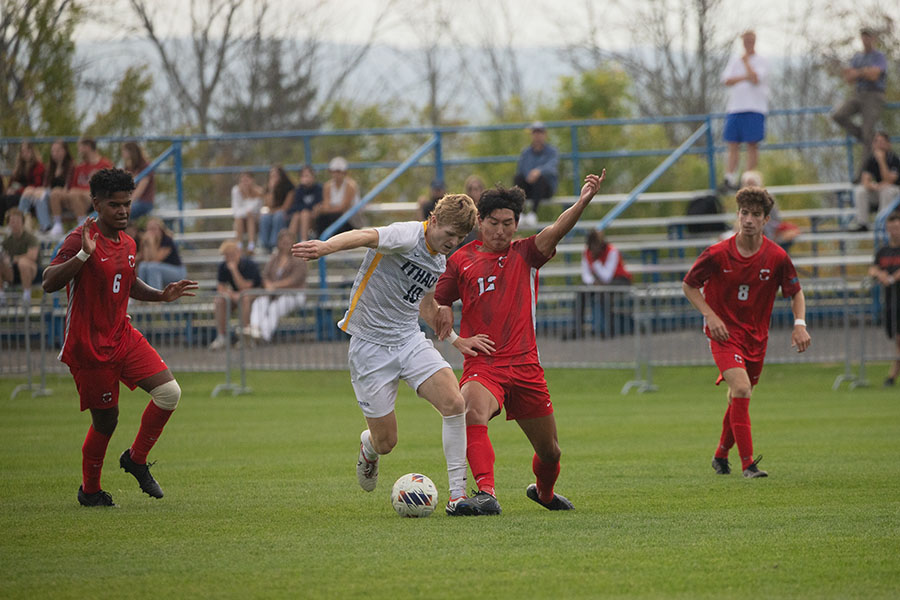 Senior midfielder Connor Tierney battles for possession against Red Dragons sophomore defender Josh Chung. The Bombers fell 2-1, as the Red Dragons took early control of the match.