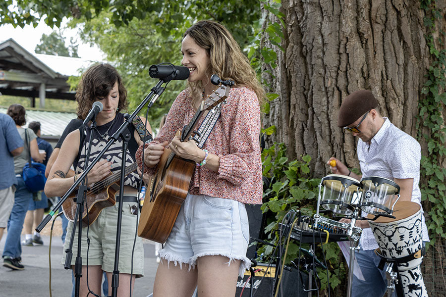 From left to right, musical artists Hannah Toombs, Susannah Lee and Jeremy Faulk perform at the Ithaca Farmer's Market. New Student Transition Programs hosted a field trip on Saturday Sept. 1 to the market and provided buses on loop from 10:00 a.m. to 3:00 p.m.