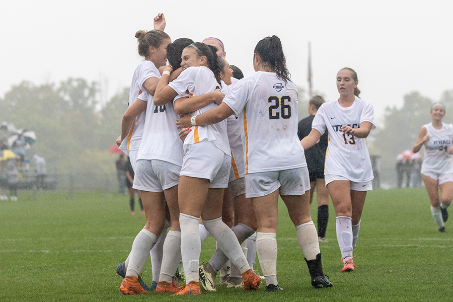 The Ithaca College women's soccer team huddles during its Senior Day victory over Bard College. The Bombers scored seven goals from six different players while holding the Raptors to just one shot.