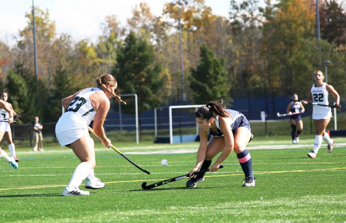 Senior striker Juliana Valli battles for possession with Herons' first-year defender Caroline Kogut during the Bombers' 2-1 loss to William Smith College. The Bombers took an early lead, but the Herons rallied for a second-half comeback.