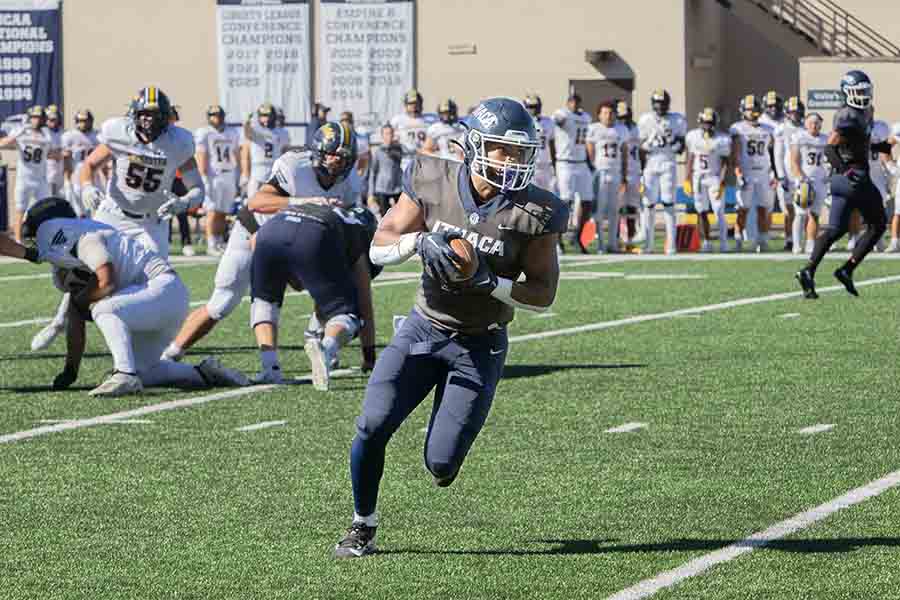 The Ithaca College football team returned to the win column by defeating the University of Rochester Yellowjackets Oct. 12. Pictured, senior running back Jalen Leonard-Osbourne breaks away from the defense.