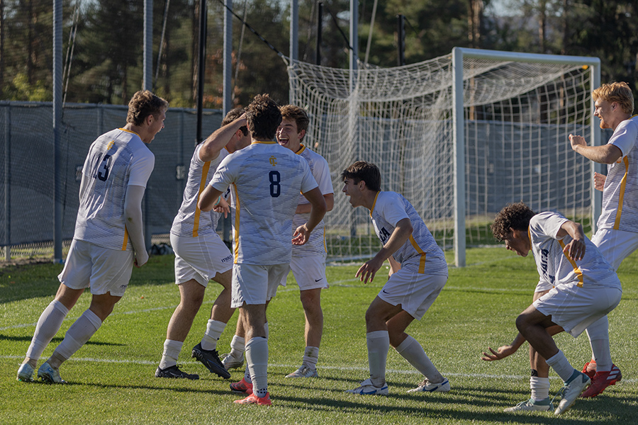 The Ithaca College men's soccer team celebrates during its 2–0 victory over Clarkson University, ending a three-game scoring drought.