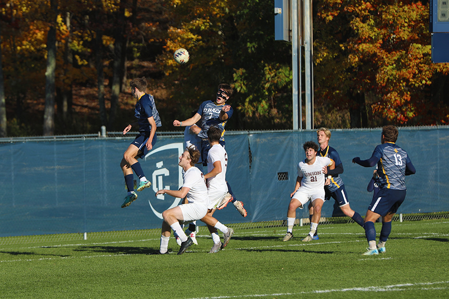 Sophomore Jack Carney jumps up to win a header.