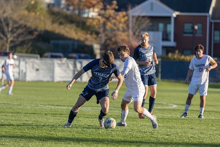 Sophomore midfielder Jack Carney attempts to maneuver around his defender.