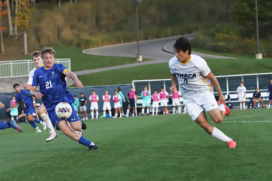 Junior forward Andrew Kusek and Continentals senior midfielder Luke Ehrenfreund race for the ball.