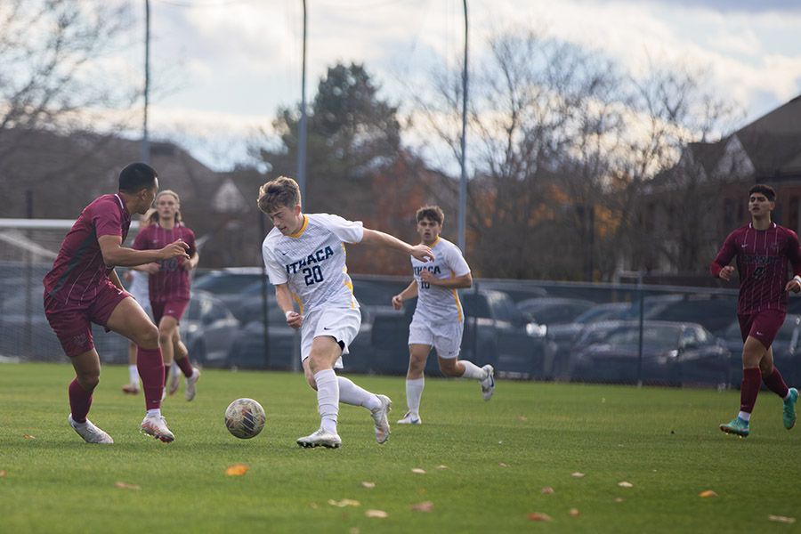 Senior midfielder Landon Hellwig dribbles the ball against a Vassar defender. The Bombers defeated the No. 12 Vassar College Brewers, scoring four goals in the victory.