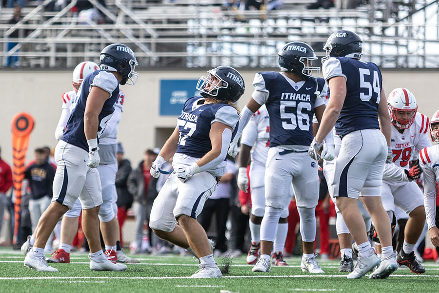 First-year Logan Kursweg, defensive lineman for the Ithaca College junior varsity football team, celebrated with his teammates. The team won against Cortland's JV team at their game on Oct. 27. This game is known as the "Cortaca Mug."