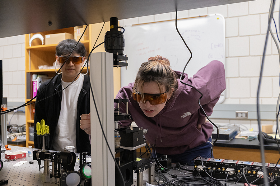 From left, junior José Rojas, a mathematics/physics major, and sophomore Fiona Lorenzen, an applied physics major, study colloidal particles, microscopic particles that are held in water, with optical tweezers.