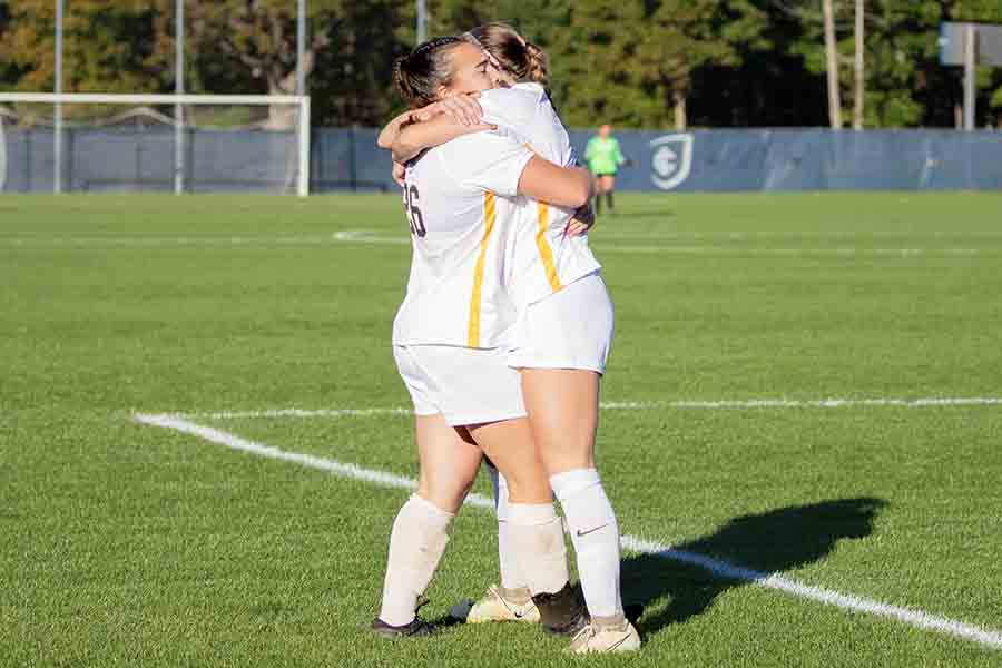 Pictured, senior forward/midfield Julia Cascone and sophomore midfield/defense Zara Nourie share a moment during the Bombers' win.
