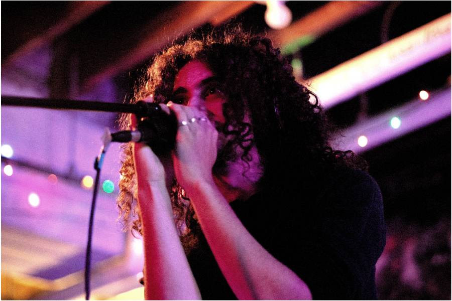 Leaning into the mic is junior Joseph Wolff plays the keyboard for "Good Head," at their performance for Thread Magazine.