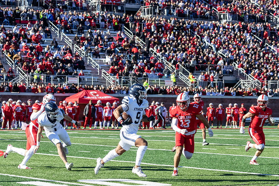 The Ithaca College and SUNY Cortland football teams renewed their rivalry in the 65th annual Cortaca Jug game on Nov. 16, with the Bombers falling to the Red Dragons, 28-17. Pictured, sophomore wide receiver Nicholas Lang moves the ball down field as Red Dragons' sophomore defensive back Anthony Luciano approaches to make the tackle.