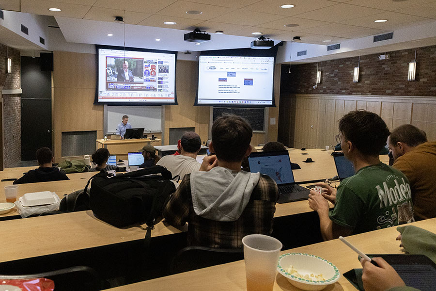 Students watch the results of the presidential election crawl in on Nov. 5 at an election watch party organized by the Department of History.