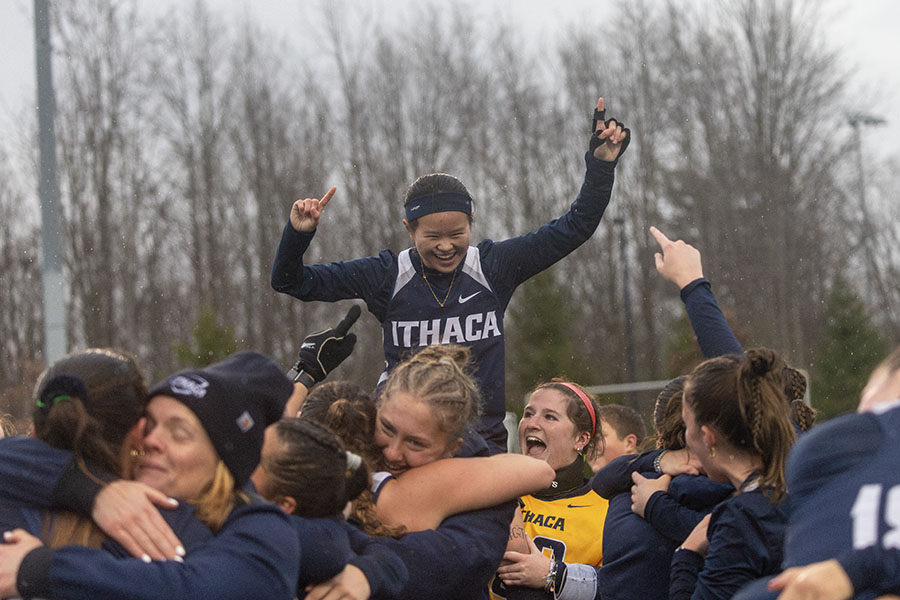 The Ithaca College field hockey team celebrates its Liberty League Championship win against the University of Rochester Yellowjackets. Pictured, the team holds up first year striker Mia Woodard in an act of joy.