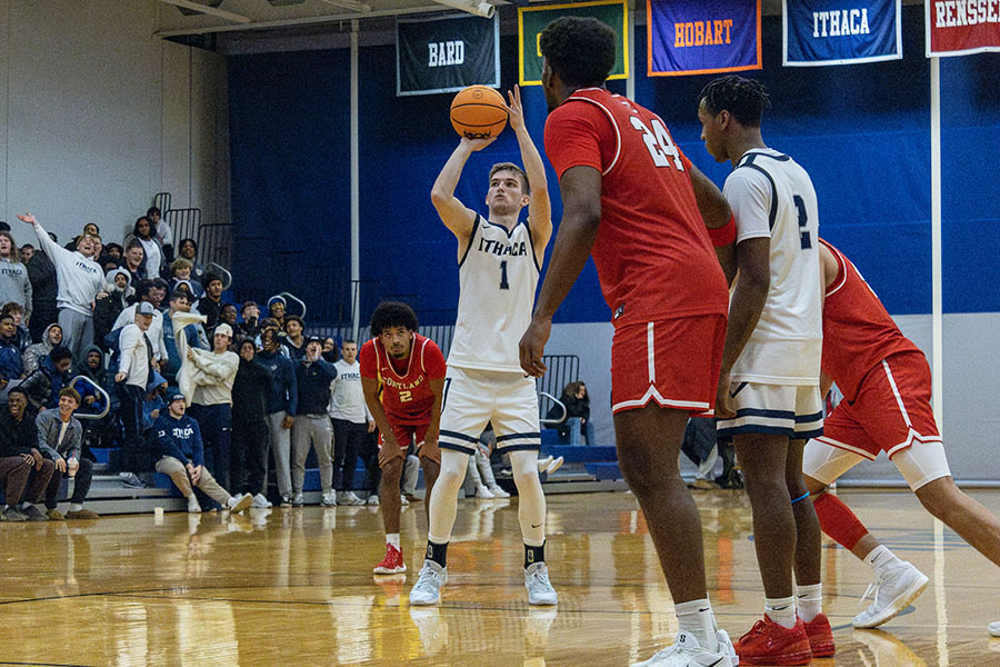 The Ithaca College men's basketball team defeated the SUNY Cortland Red Dragons in its home opener, 64-58. Pictured, senior guard Logan Wendell pulls up for a shot.