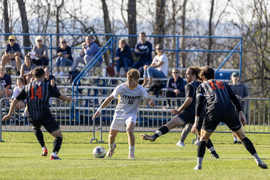 Senior midfielder Connor Tierney dribbles the ball while surrounded by multiple defenders.